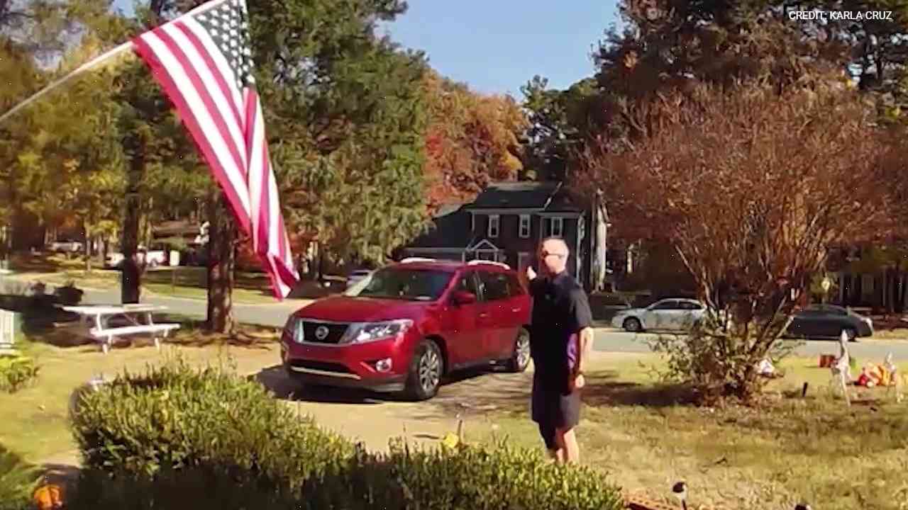 US driver is dubbed 'an unofficial unofficial of the Welcoming Centre' after carrying American flag